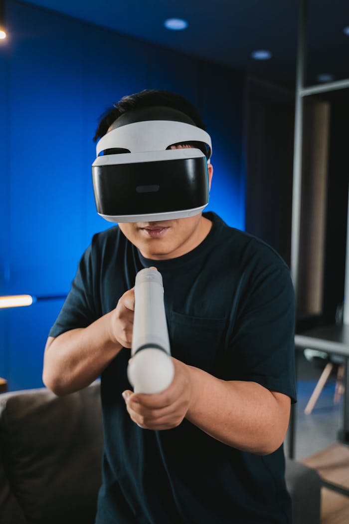 A man enjoying a virtual reality gaming experience indoors, holding a controller.